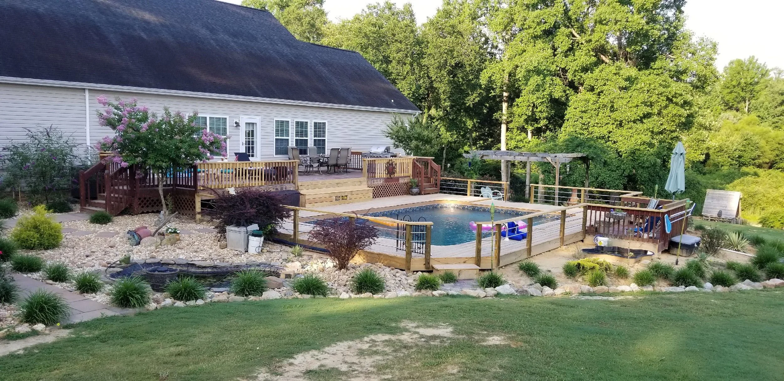 Hybrid Oasis above-ground pool with wraparound deck installed by US-1 Pools