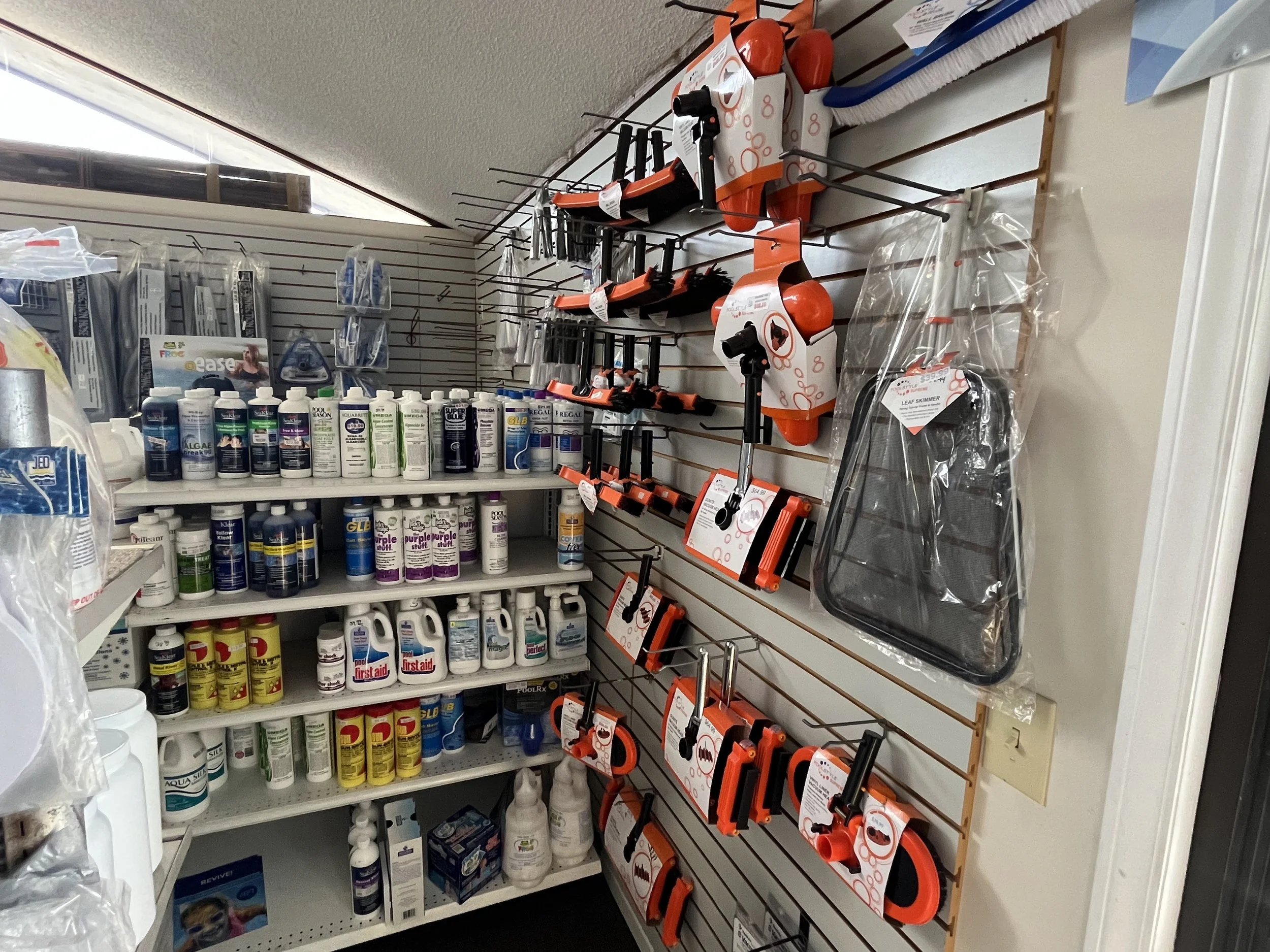 Pool chemicals, nets, and cleaning accessories in the US-1 Pools showroom