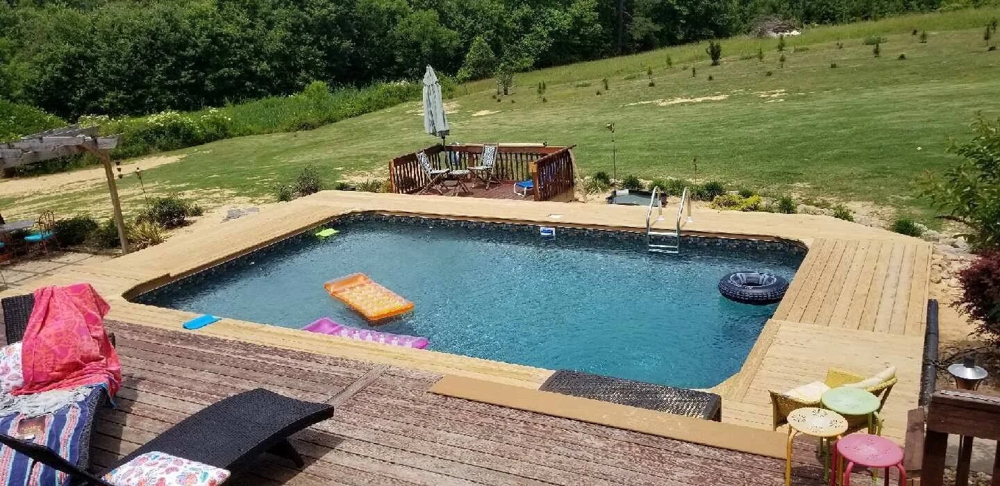 Steel wall in-ground pool with deck