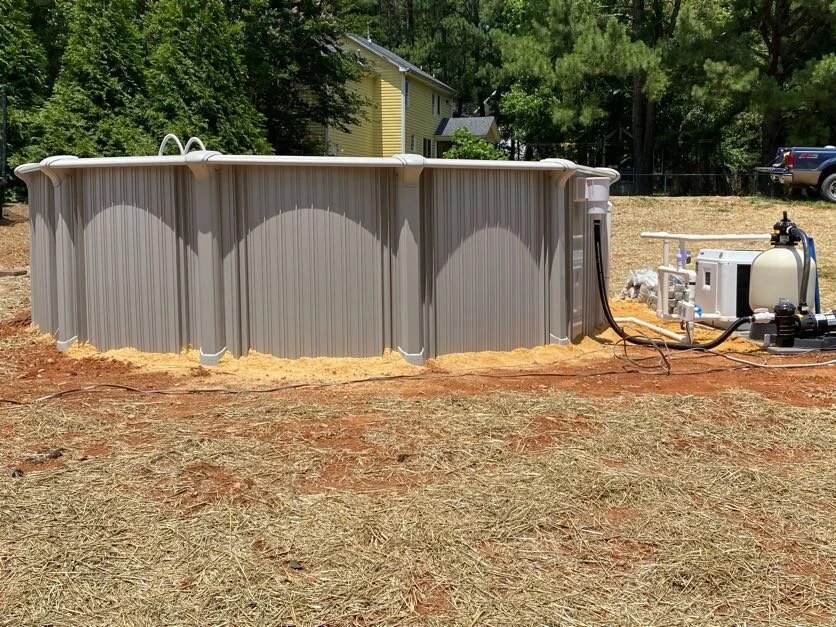 Pool pump and filter system installed beside an above-ground pool