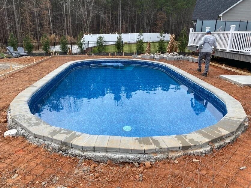 Aquasport hybrid above-ground pool with stone surround